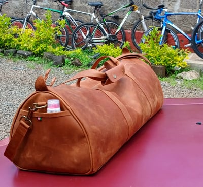 Custom-made, light brown leather duffle bag within custom made realization