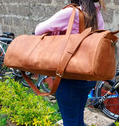 Custom-made, light brown leather duffle bag within custom made realization