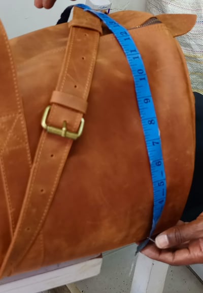 Custom-made, light brown leather duffle bag within custom made realization