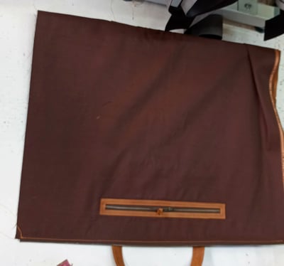 Custom-made, light brown leather duffle bag within custom made realization