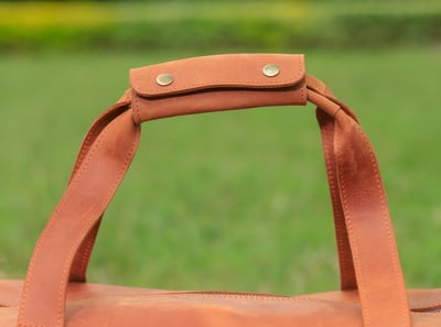 Custom-made, light brown leather duffle bag