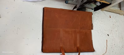 Custom-made, light brown leather duffle bag within custom made realization