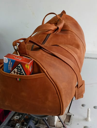 Custom-made, light brown leather duffle bag within custom made realization